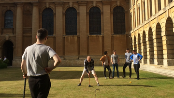 Students playing croquet at Queens
