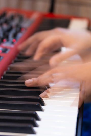hands playing a keyboard