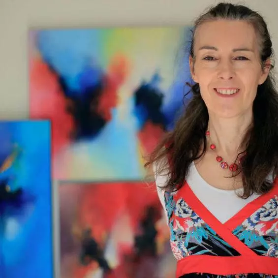 Jude Caisley in front of her artwork