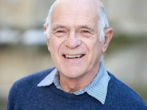 A headshot of Michael Green smiling